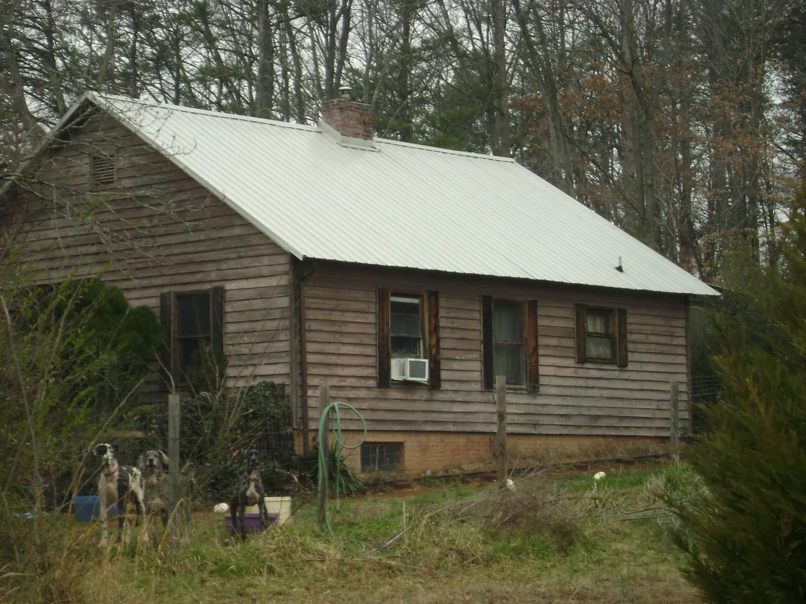 White metal roof on an old wood sided farmhouse, from a Metal Roof Installation job in Irvington