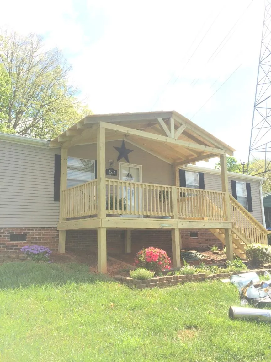 New gabled porch roof and deck railing added to a ranch home in Irvington